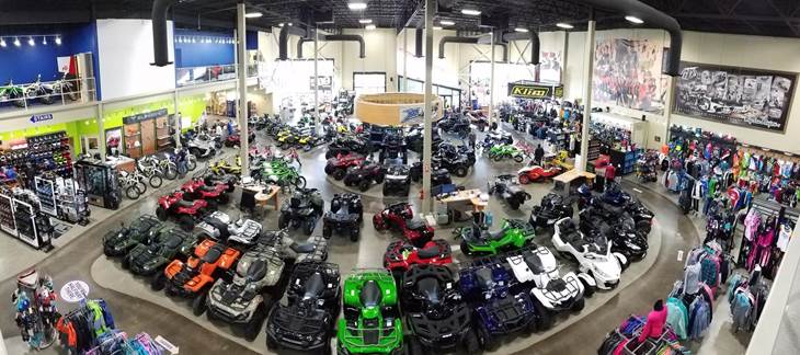 An aerial view of the showroom floor full of brightly colored ATVs, bikes, and clothing.