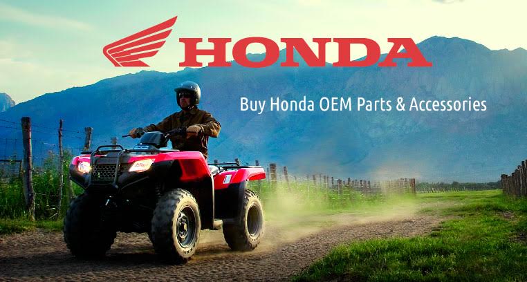 A man rides a red Honda ATV on a dirt path.
