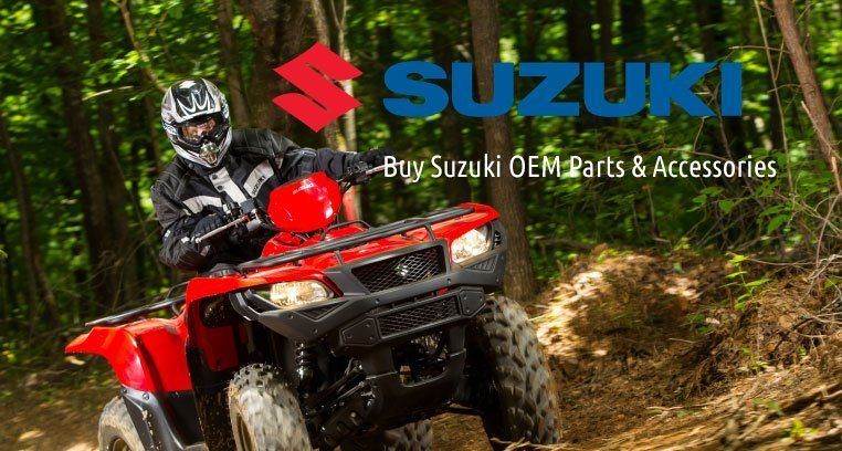 Man rides a bright red ATV through the forrest.